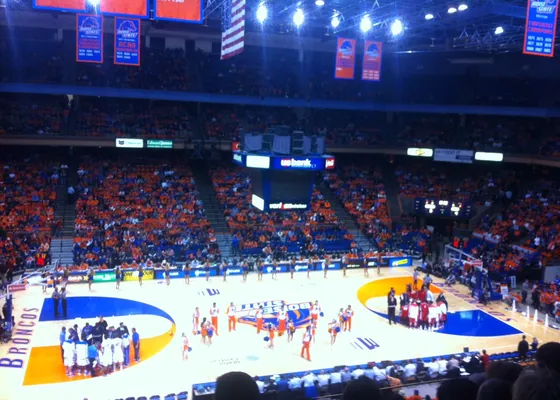 A college basketball game in front of a full arena.