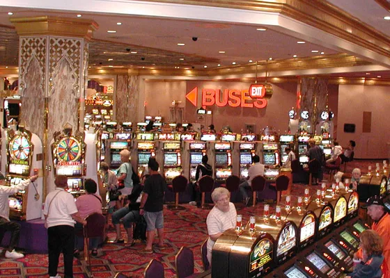 Banks of slot machines stretch the length of a casino aisle.
