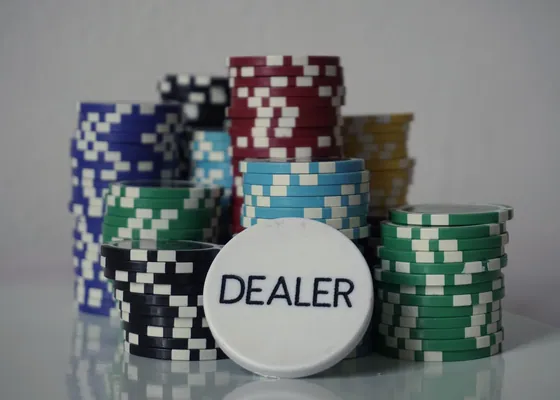 Poker chips stacked behind the dealer button.