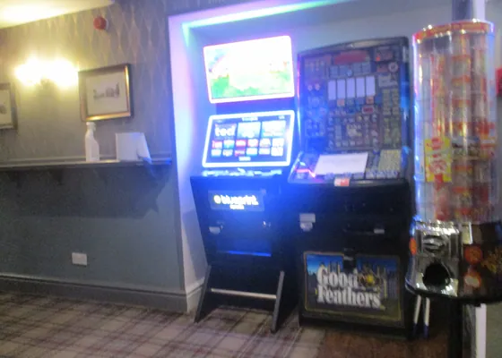 A fruit machine tucked into the corner of a pub.