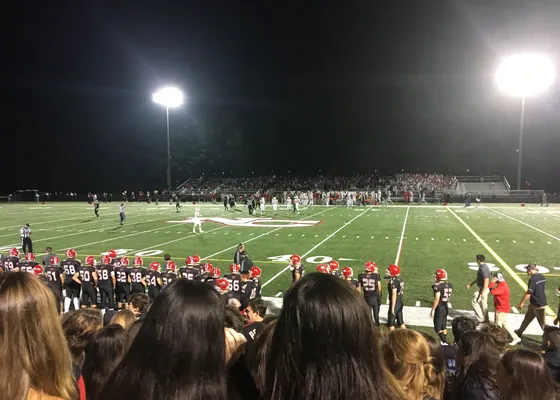 A high-school football game under the lights.