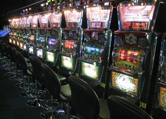A row of machines, each with its own screen and bill acceptor.